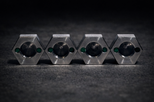 Four stainless steel Dognuts viewed from the back, with green locking pegs beside each threaded opening.